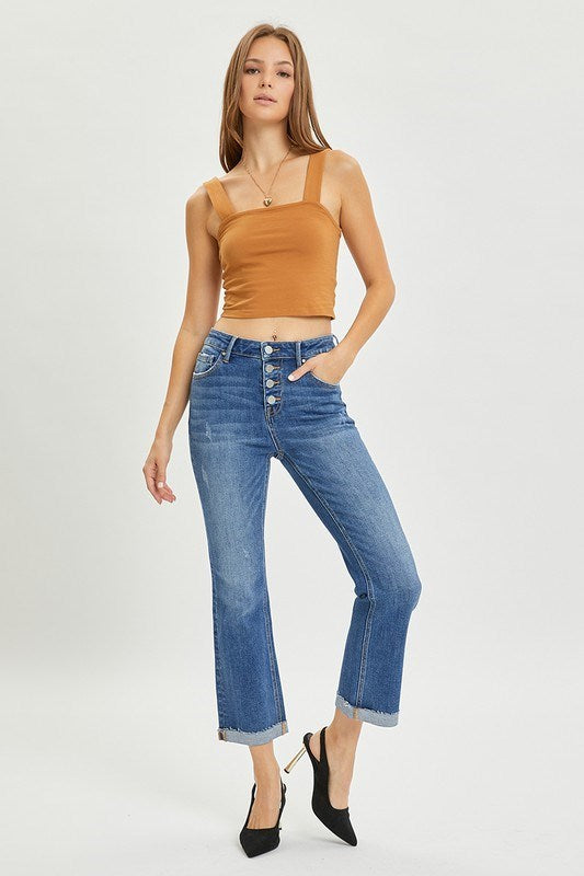 Woman wearing RISEN JOSIE high rise button fly straight leg jeans paired with a brown top and black heels.