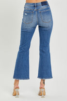 Back view of Risen Kelsey Midrise Cropped Flare Jeans showcasing trendy denim style with frayed hem.