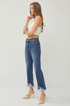 Risen Phoebe Jeans in dark wash with shark bite hem, styled with a fitted crop top and heels.