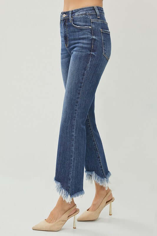 Risen Phoebe Jeans in dark wash featuring chic shark bite hem and mid-rise fit, styled with ankle boots.