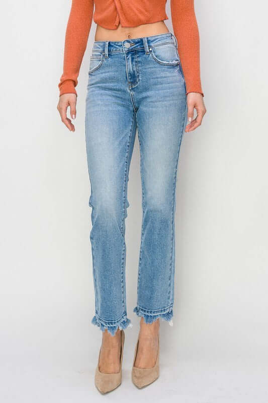 Woman wearing RISEN Gracie high-rise straight fit jeans with a distressed finish and pointed heels.