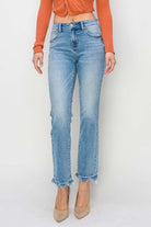 Model wearing RISEN Gracie Jeans, high-rise straight fit with distressed finish, paired with a stylish top.