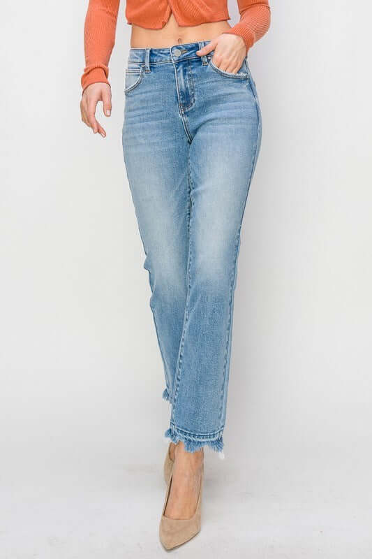 Model wearing RISEN Gracie high-rise straight fit jeans with distressed finish, styled with a trendy top and heels.