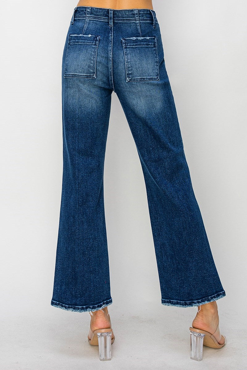 Back view of ALIZA JEANS by Risen showing high-rise flare denim with patch pockets and trendy frayed hem.