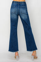 Back view of ALIZA JEANS by Risen showing high-rise flare denim with patch pockets and trendy frayed hem.