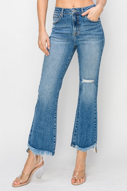 FAE JEANS by Risen in medium-light wash, high-rise flare jeans with frayed hem and lightly distressed details.