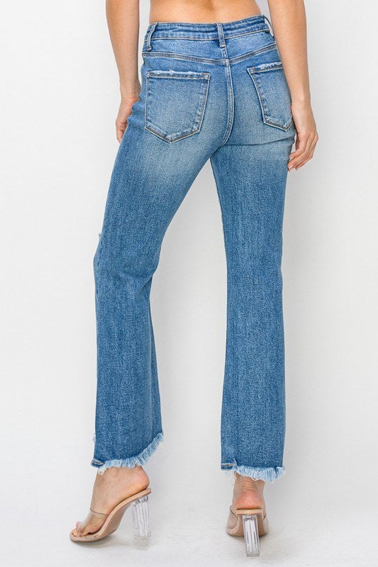Back view of FAE JEANS by Risen featuring high-rise flare design and frayed hem for a trendy look.