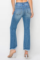 Back view of FAE JEANS by Risen featuring high-rise flare design and frayed hem for a trendy look.