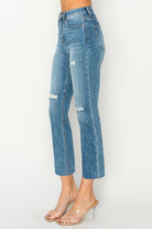 Celeste high-rise distressed slim straight jeans by Risen, featuring a sleek silhouette and modern style.