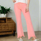 Sierra Sky Denim Jeans in playful flamingo pink wash, featuring a mid-rise fit and trendy raw hem.
