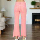 Back view of Risen Sierra Sky Flamingo Pink Jeans, showcasing flared bottoms and relaxed fit.