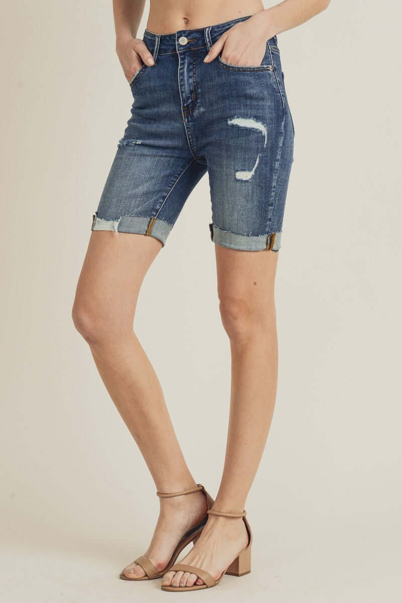Risen Shayleigh Bermuda Shorts featuring distressed denim and optional cuffed hem, styled with heeled sandals.