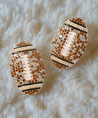 Football-themed rhinestone earrings on fur background, perfect for adding glam to Fall outfits and showing team spirit.