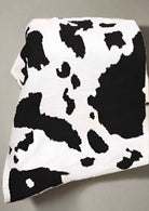 Cozy Cow Blanket with black and white cow print by Howdy Honey, ultra-soft polyester microfiber for maximum comfort.