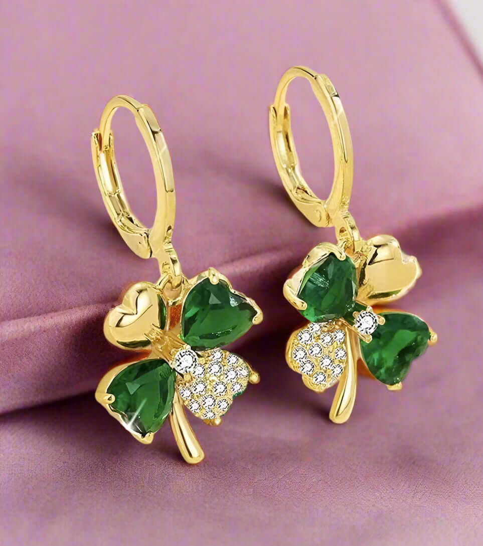 Gold-tone So Lucky Earrings with green faux gemstones and rhinestones, featuring a charming four-leaf clover design.