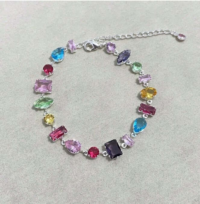 Luxurious gemstone cascade bracelet in vibrant hues, set in silver tones with cubic zirconia gems.