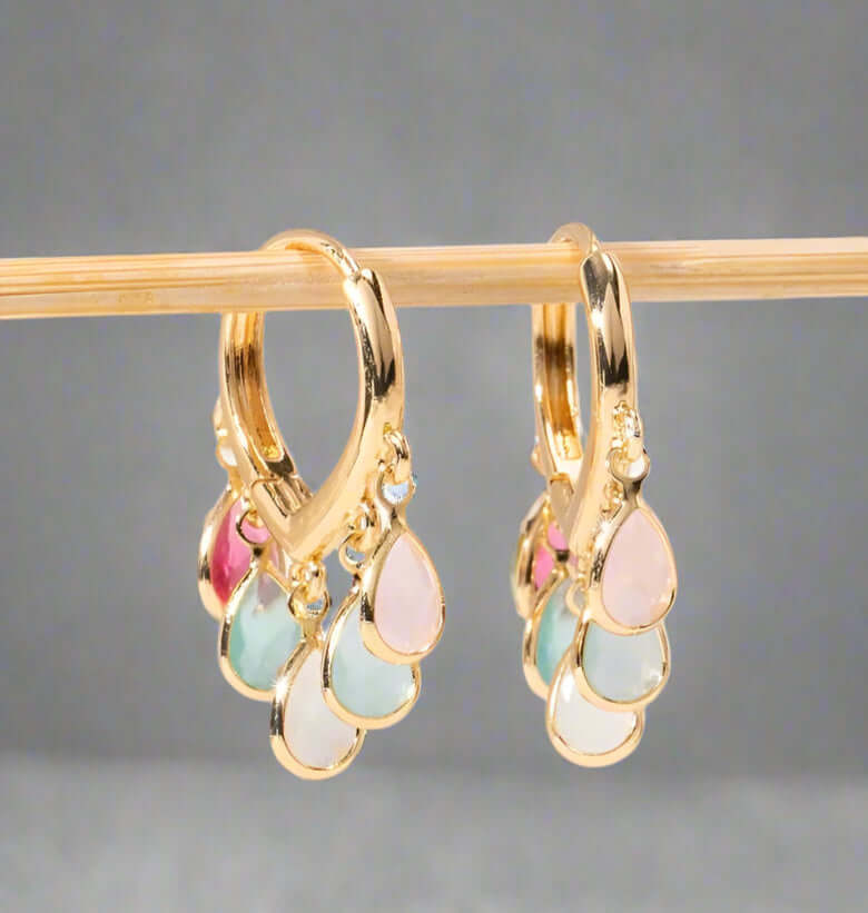 Stunning stained glass earrings with gold accents and colorful teardrop gemstones in pink, green, and blue.