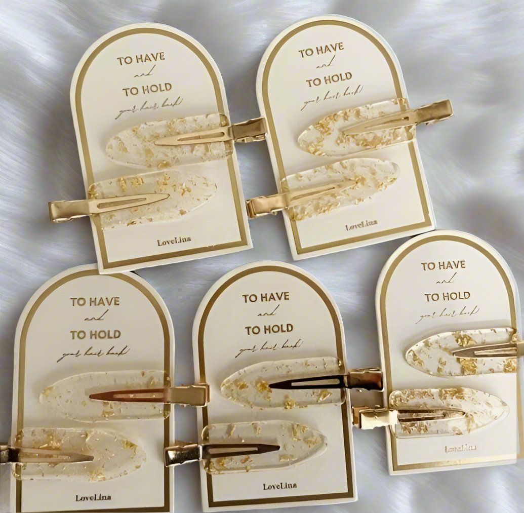Set of gold hair pins with clear acrylic and gold flecks, ideal for elegant updos and securing hairstyles.