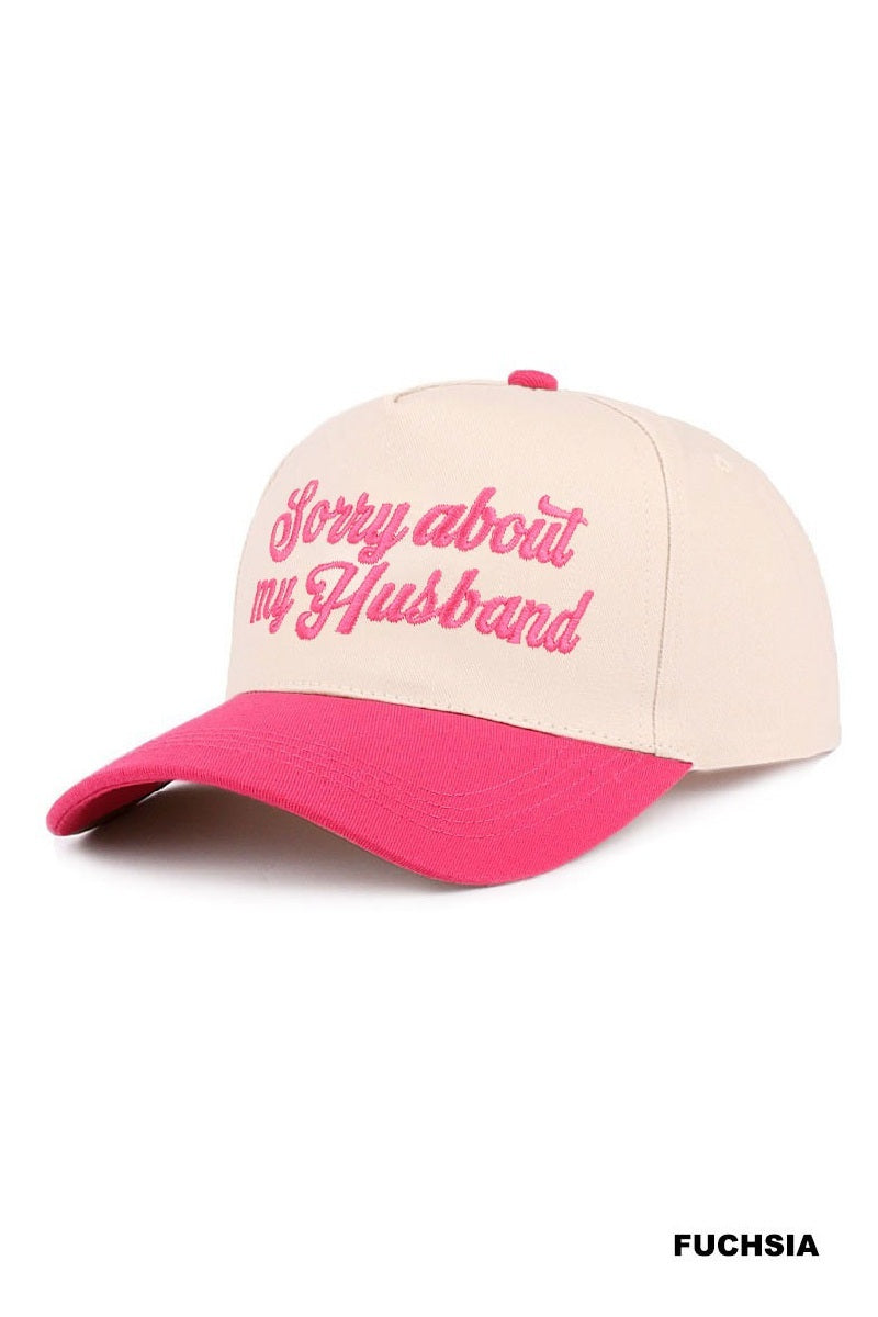 SORRY ABOUT MY HUSBAND HAT (6 colors) in fuchsia with embroidered script on a cream base.