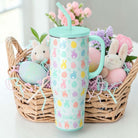 EGG HUNT 40 OZ MEGA MUG - Swig Life next to a festive Easter basket filled with bunnies and colorful eggs.