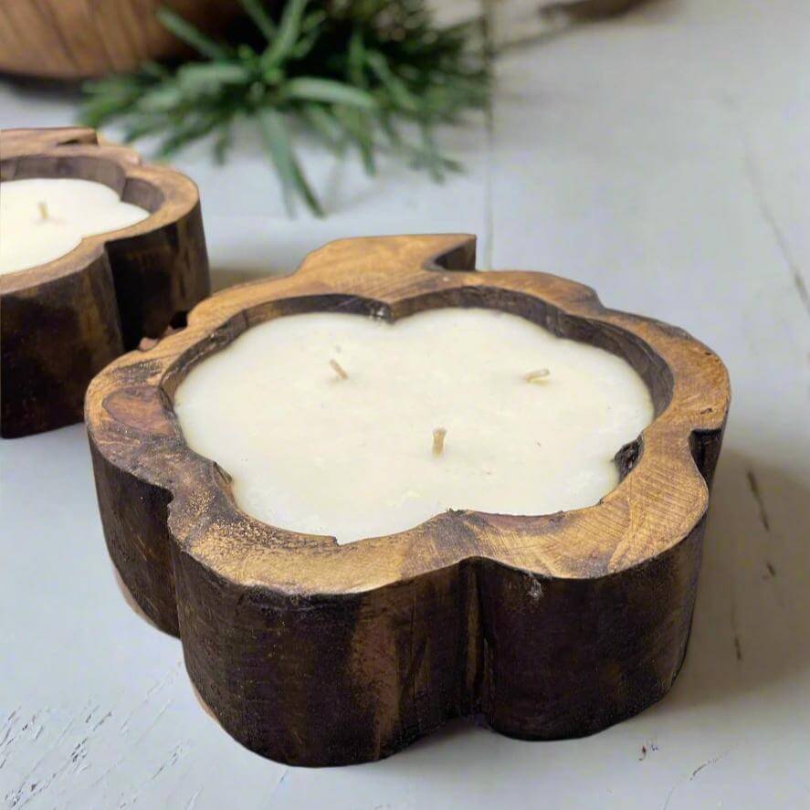 Rustic dough bowl candle with eco-friendly cotton wick and soy wax, featured in a farmhouse setting with greenery accent.