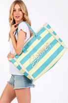 Model carrying MB0267 Sewn Tope Summer Letter Fringe Striped Tote Bag with playful fringe and vibrant colors.