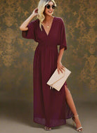 Stylish woman in a deep V neck burgundy ruffle maxi dress, perfect for casual outdoor occasions.