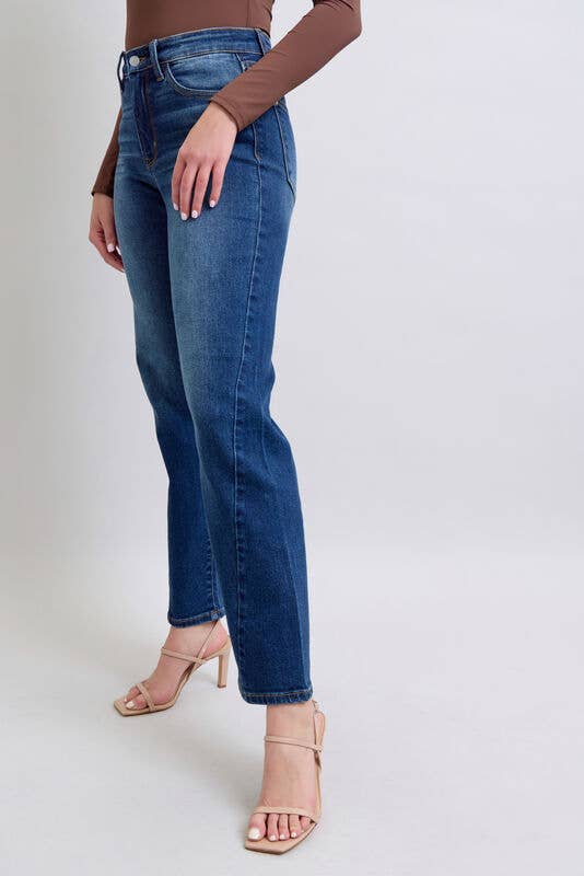 Model wearing JUDY BLUE - NOELLE JEANS with a high-rise fit and wide leg cut in dark wash denim.