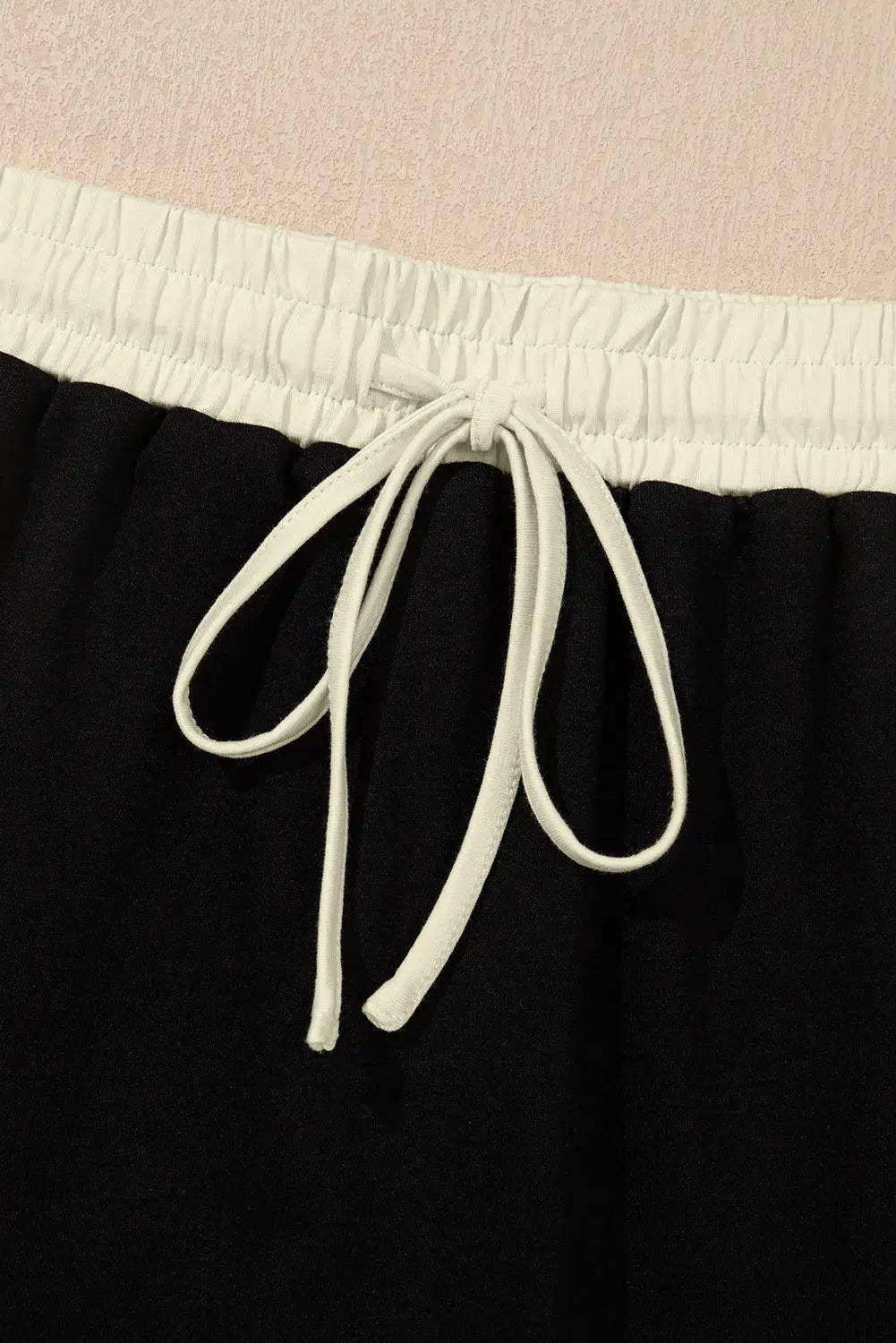 Close-up of the drawstring waist on a black skort, showcasing comfort and adjustable fit.