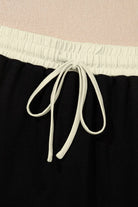 Close-up of the drawstring waist on a black skort, showcasing comfort and adjustable fit.