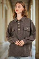 Woman wearing NT11852X-PLUS collared button down henley knit top with pockets, featuring oversized fit and drop shoulders.