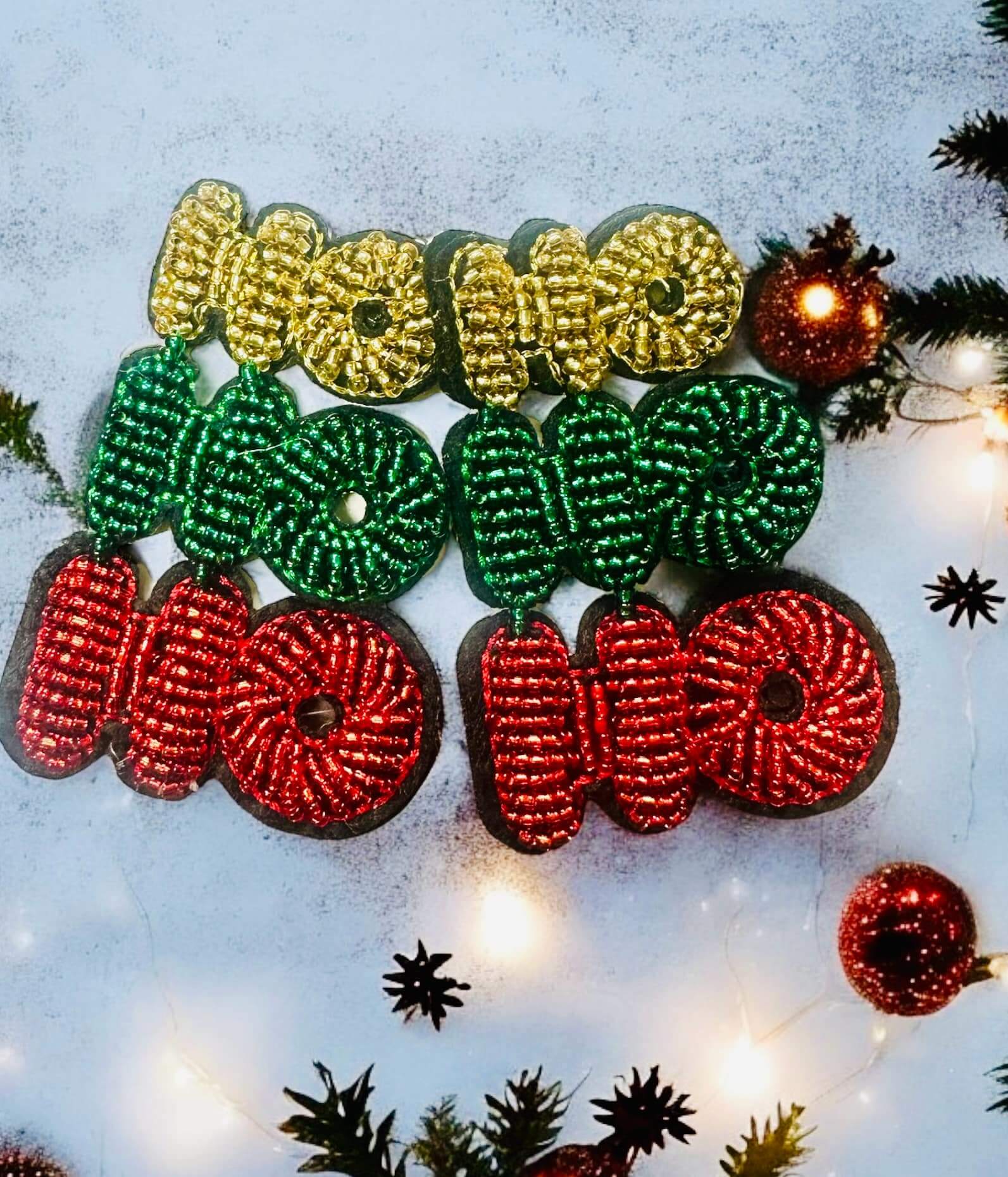 Colorful Ho Ho Holidays seed bead earrings in gold, green, and red, perfect for festive celebrations. Size 2.5 X 1.5 inches.