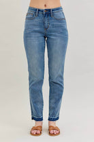 Model wearing JUDY BLUE - AVERY JEANS featuring a mid-rise fit and release hem detail.
