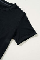 Close-up of a black t-shirt sleeve, showcasing soft fabric and rolled cuff design, perfect for casual styling.