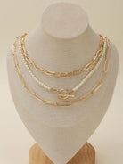 CN4261 Multi Pearl Toggle Chain Necklace Set displayed on a bust, showcasing three layered necklaces with gold links and pearls.