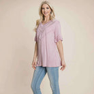 Delicate Directions soft pink top with lace trim, ruffled sleeves, perfect for casual and dressed-up occasions.