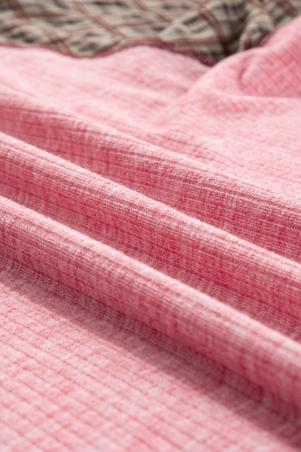 Close-up of ribbed pink fabric with textured design and mixed print details from the Mixed Blessings Top.