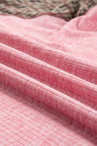 Close-up of ribbed pink fabric with textured design and mixed print details from the Mixed Blessings Top.