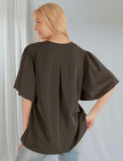 Black loose blouse with petal flutter sleeves and relaxed fit, perfect for elegant and comfortable styling.