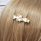 Pearl accent hair clip showcased on blonde hair, part of a 4 pcs clip set, elegant and stylish for any occasion.