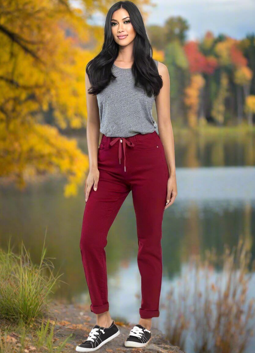 Woman wearing Judy Blue Crimson High Rise Joggers with drawstring waistband and relaxed fit, styled for fall casual look.