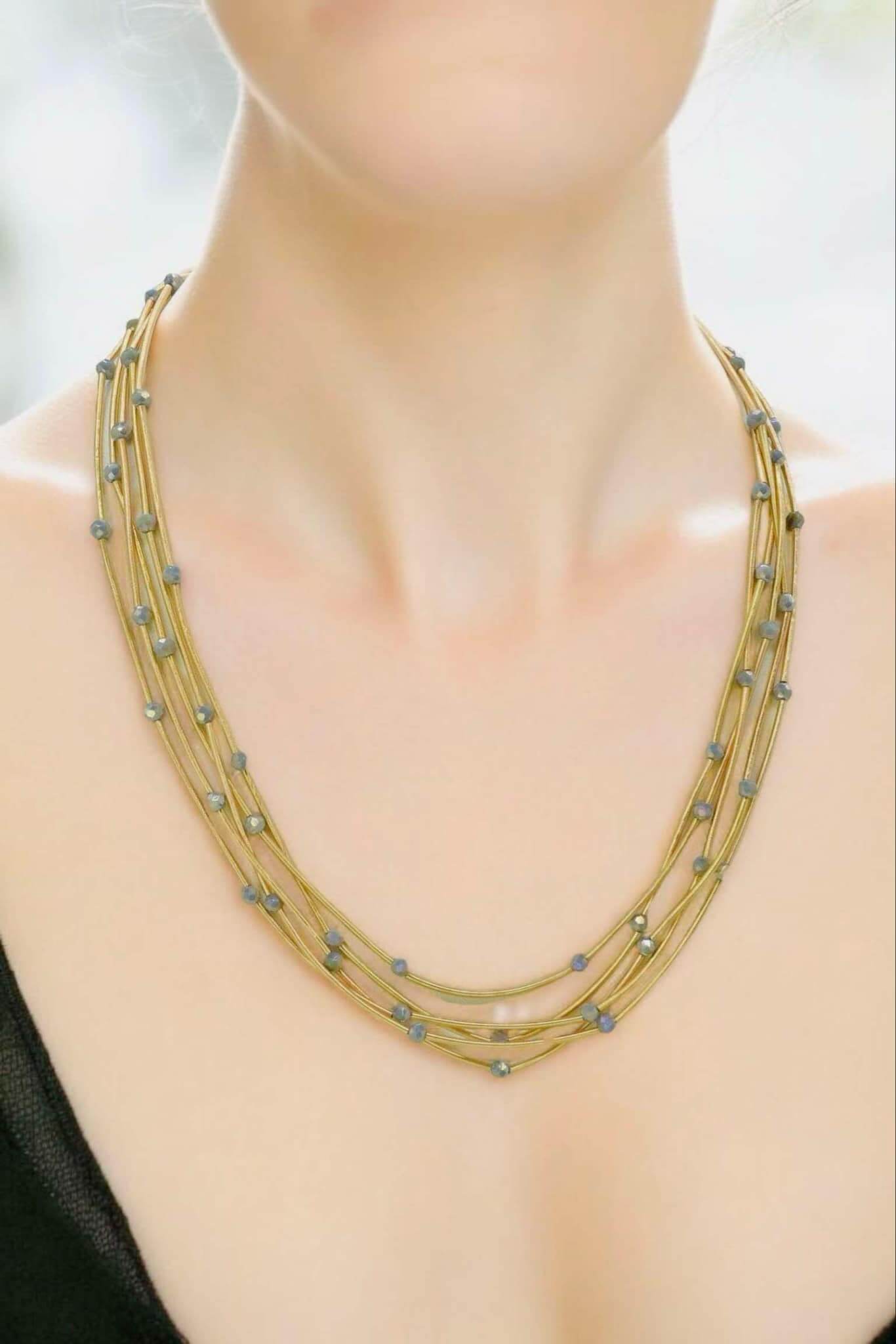Pretty Strands Necklace by Nine, featuring gold tone strands and glass beads, adjustable length, versatile accessory.