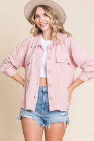 Women's embossed soft casual shacket in pink, featuring dolman sleeves and flap pockets, styled with shorts.