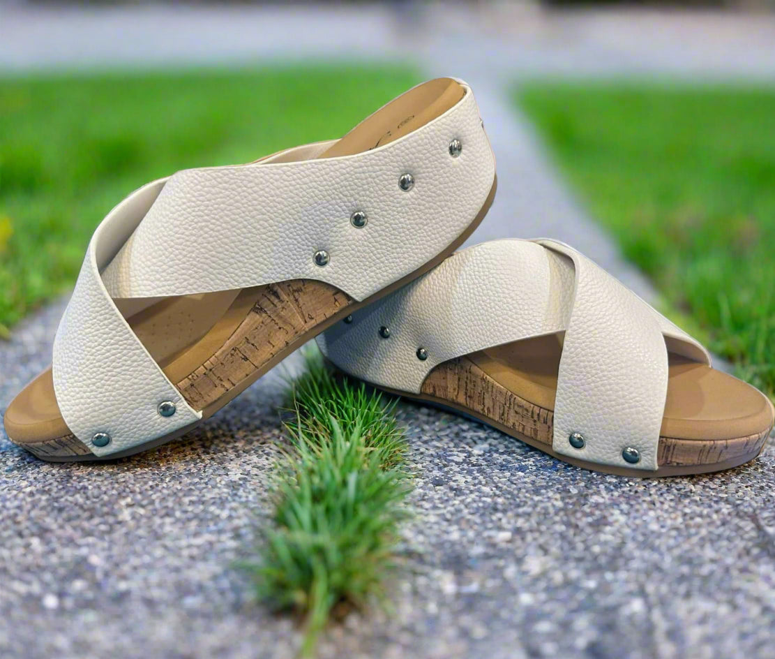 Stylish Sugar Stroll Wedge Sandals in white faux leather with crisscross straps and cork sole, perfect for sunny days.