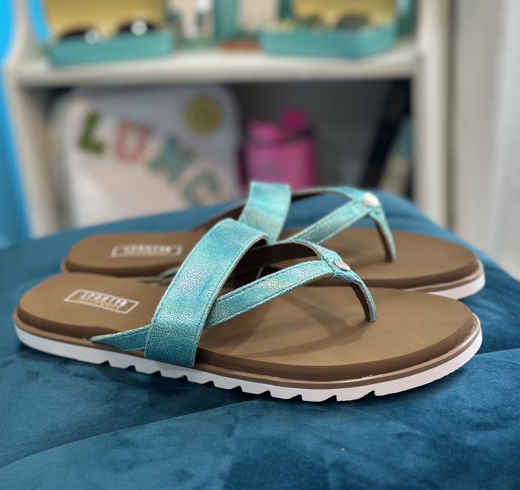 Yellow Box Shayne turquoise flip-flops on a blue surface, perfect for sporty summer outings.