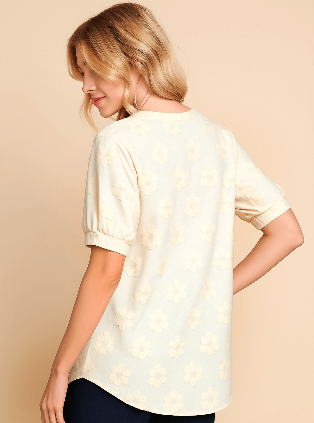 Back view of cream Field of Daisies Top with textured daisy embroidery and soft puff sleeves.