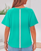 Teal Ribbon Theory Top showcasing lace bow detail and raw edge trim from the back angle, perfect for casual chic style.