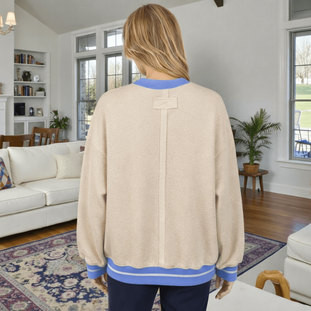 Back view of the DAYDREAM BELIEVER - Sage + Fig (beige) pullover showcasing its relaxed fit and unique design.