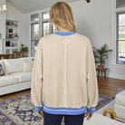 Back view of the DAYDREAM BELIEVER - Sage + Fig (beige) pullover showcasing its relaxed fit and unique design.
