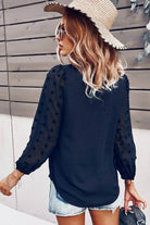 Back view of a woman wearing a navy Chateau Charm Top with Swiss dot sleeves and a straw hat.
